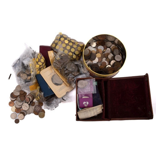 639 - A bag and tin containing a quantity of British and world coins, farthings to crowns.