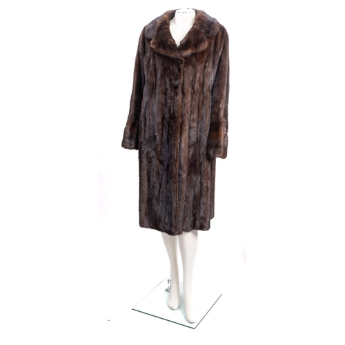 683 - An early 20th century Debenham & Freebody full length fur coat,  signed as per title with silk linin... 