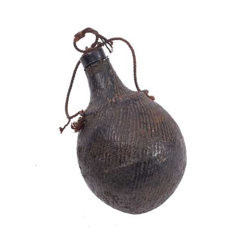 79 - A leather covered wooden powder flask with stopper. Spherical shape with funnelled spout and string ... 