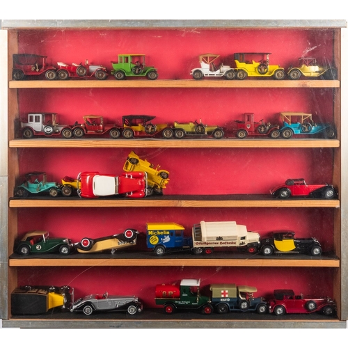 813 - A collection of diecast vehicles in three display cabinets. Comprising Corgi, Matchbox and Lledo lor... 