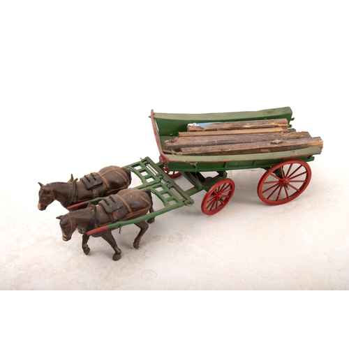 837 - A collection of four Britains diecast horse and cart sets. Comprising a four wheel flatbed cart, two... 