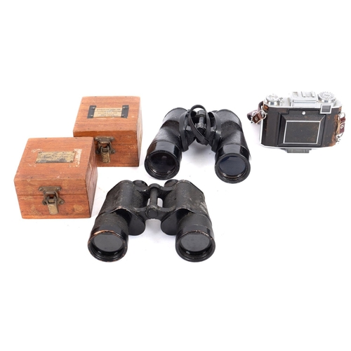 84 - Two pairs of binoculars with attachments. Including a pair of Dienstglas 10x50 binoculars and two Ba... 