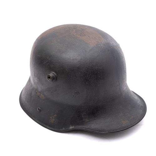 166 - A WWI period German M1916 Stahlhelm, hand painted camouflage finish with white leather liner, the he... 