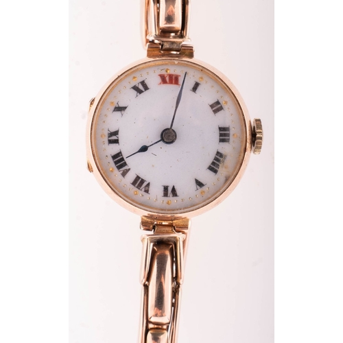 353 - A 9K gold lady's wristwatch the round white dial having black and red Roman numerals and blued steel... 