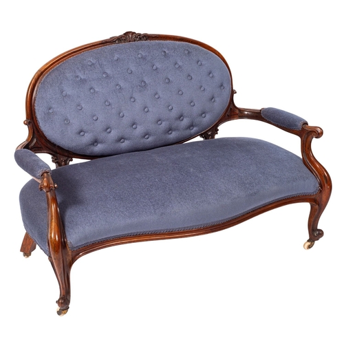 A Victorian carved rosewood settee, the oval upholstered panel button ...