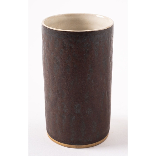 24 - *Dame Lucie Rie DBE [1902-1995] a stoneware cylinder vase or beaker, with manganese glazed exterior ... 