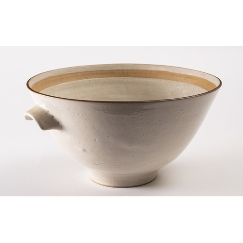 31 - *Dame Lucie Rie DBE [1902-1995] a large white stoneware bowl, with lug handles the pitted off white ... 