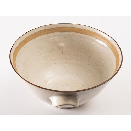 31 - *Dame Lucie Rie DBE [1902-1995] a large white stoneware bowl, with lug handles the pitted off white ... 