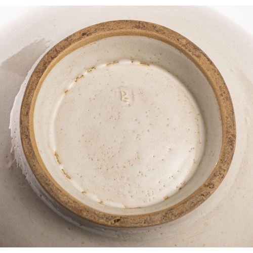 31 - *Dame Lucie Rie DBE [1902-1995] a large white stoneware bowl, with lug handles the pitted off white ... 