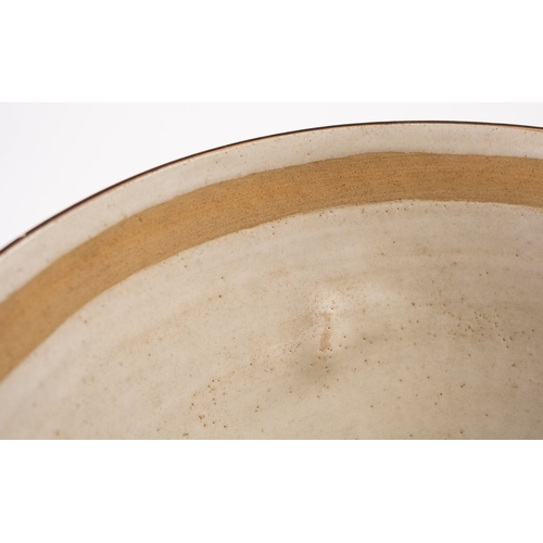 31 - *Dame Lucie Rie DBE [1902-1995] a large white stoneware bowl, with lug handles the pitted off white ... 