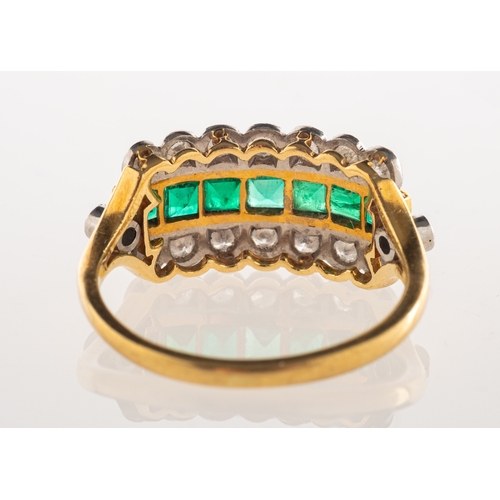 550 - A 1980's 18ct gold emerald and diamond ring, a three row ring, the centre channel set with square-cu... 