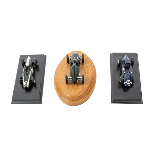 636 - A group of seven built white metal Cooper racing cars, five mounted on display plinths, various make... 