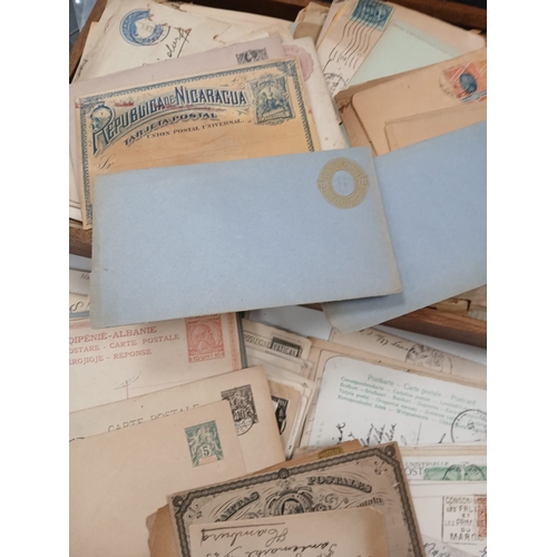 112 - World Postal History. A wooden box full of old covers, postal stationery, and postcards, early to mi... 