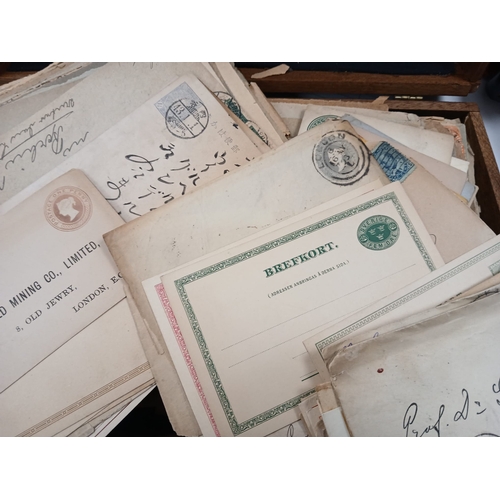 112 - World Postal History. A wooden box full of old covers, postal stationery, and postcards, early to mi... 