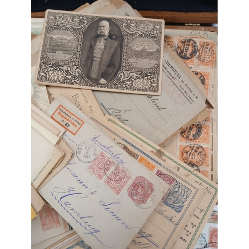 112 - World Postal History. A wooden box full of old covers, postal stationery, and postcards, early to mi... 