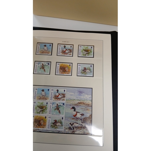 63 - Alderney. A collection of stamps from Alderney in two boxed hingeless albums, together with a quanti... 