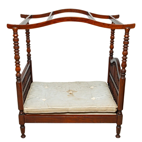 A doll's stained beech four-post bed, later 20th century; the openwork ...