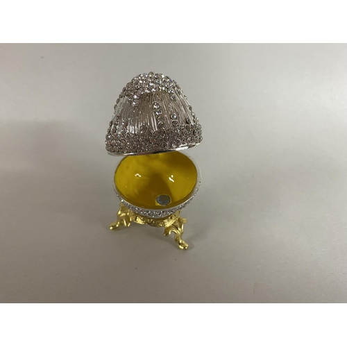 172 - Jewelled, enamelled & hinged Trinket Box in form of an Egg