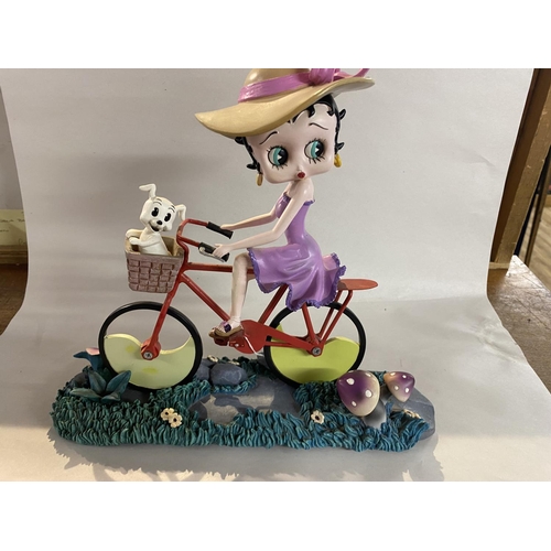 57 - Betty Boop Riding a Bike on Stand - 27cmH x 30cmL - Small Chip on Hat