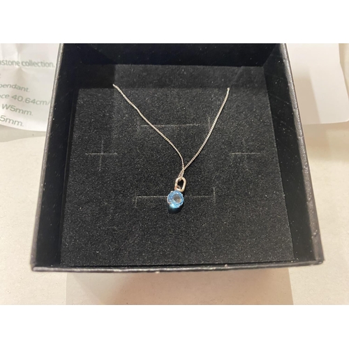 201 - 9ct Gold & Blue Topaz Pendant on White Gold Chain