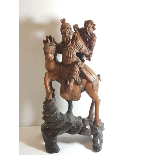 5 - Oriental carved hardwood figure of a horse carrying 2 men. Approx. 21