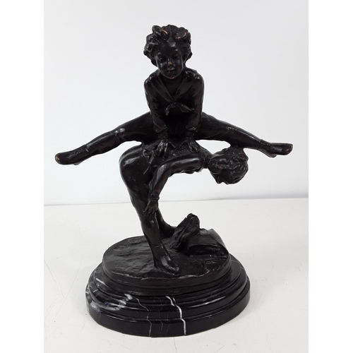 76 - Cast bronze leapfrog figure on marble base