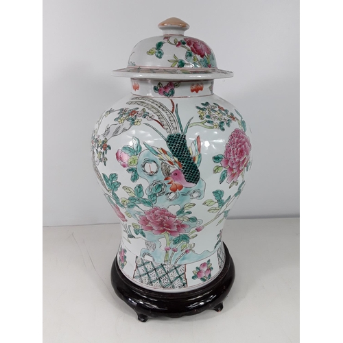 163 - Large oriental jar and cover on wooden base approx 19 inches overall