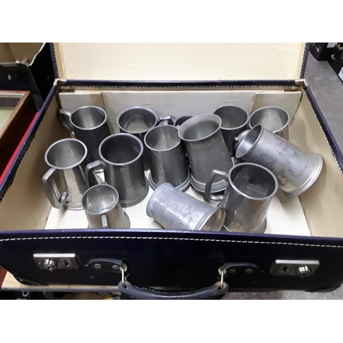 307 - Suitcase of pewter tankards