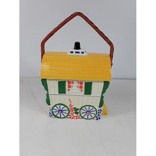 39 - Porcelain biscuit barrel in the form of a gypsy caravan