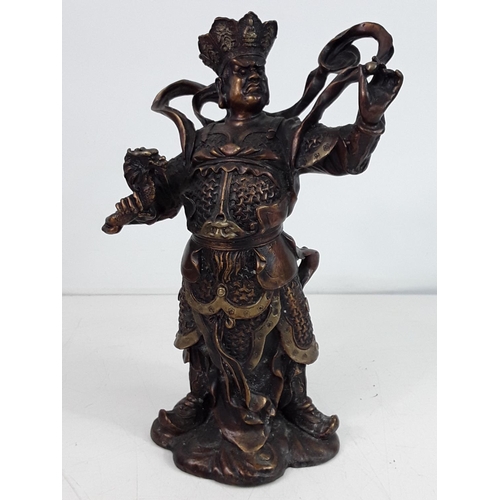 28 - Cast bronze oriental god figure approx 10 inches tall