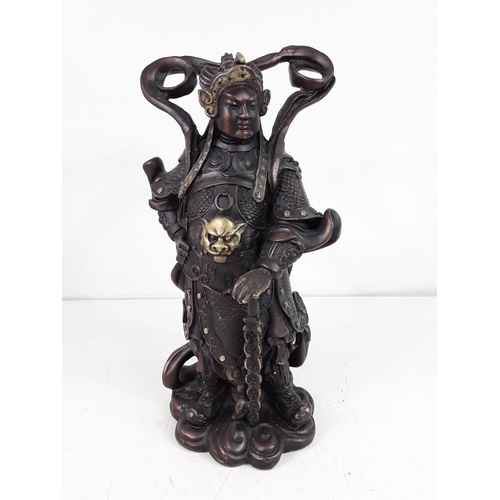 29 - Cast bronze oriental god figure approx 10 inches tall