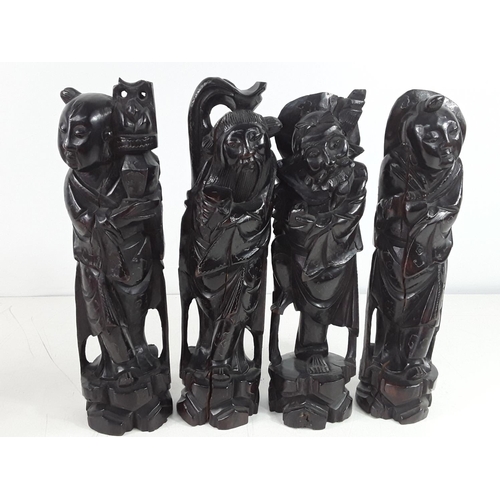 14 - 4 oriental carved wood figures each approx 30cms