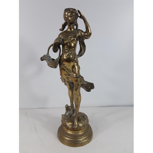 52 - Heavy brass figure of a girl carrying flowers approx 45cms tall