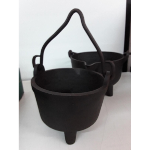 19 - 2 cast metal cauldrons