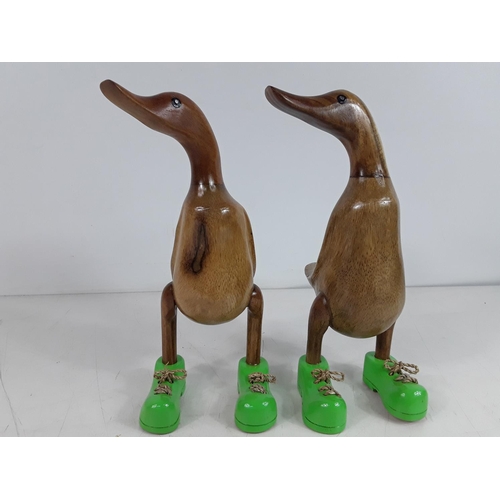 73 - 2 small carved wooden ducks with green boots