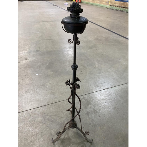 113 - ANTIQUE RISE AND FALL OIL LAMP WITH WROUGHT IRON DECORATION