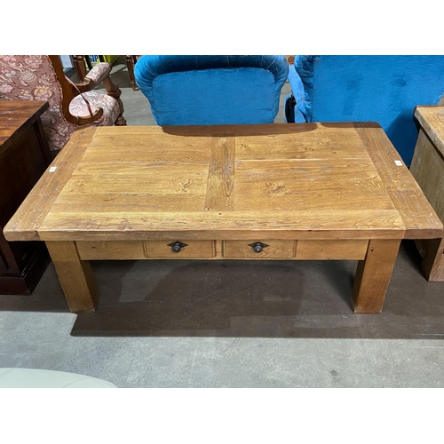 69 - LARGE OAK COFFEE TABLE APPROX 55