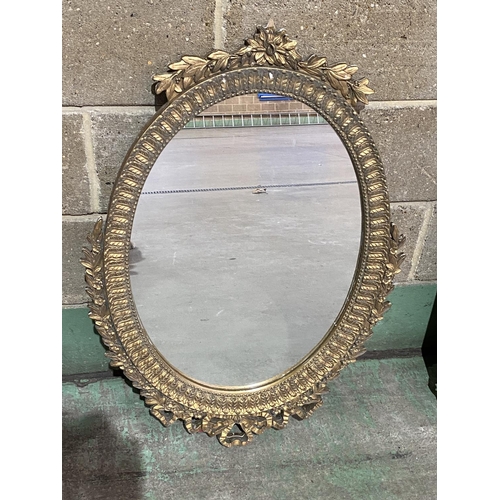 95 - ORNATE OVAL GILT FRAMED MIRROR