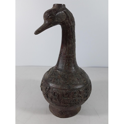 150 - Cast bronze bottle in the form of a bird head with Eastern decoration