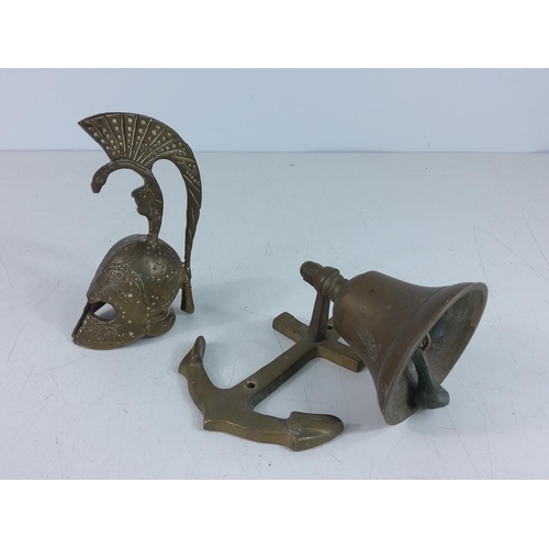 234 - Brass bell and Roman helmet