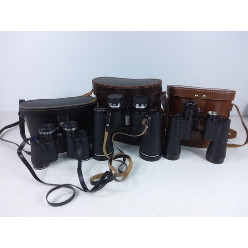 275 - 3 pairs of cased binoculars