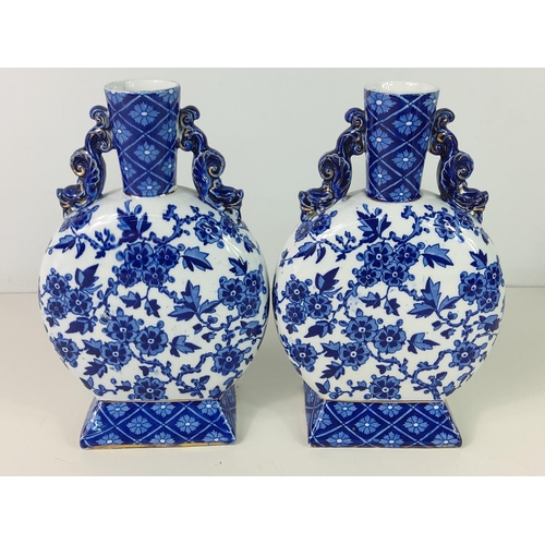 136 - Pair of blue and white moon vases, approx 23cms x 15cms x 7cms