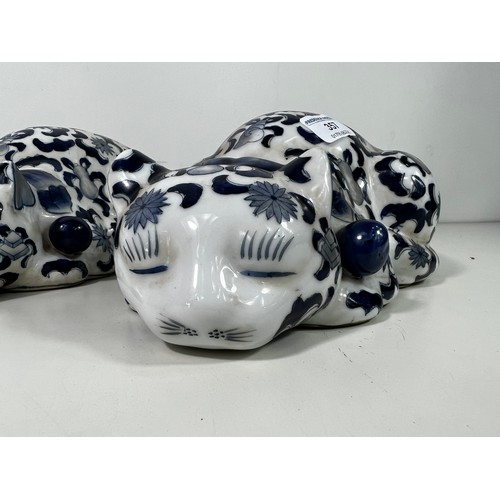 357 - Pair of blue and white porcelain cat figures