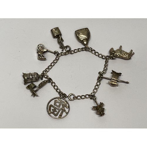 619 - Silver charm bracelet with approx 8 charms - gross 20g