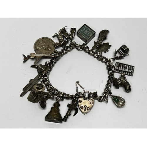 618 - Silver charm bracelet with approx 17 charms - gross 60.5g