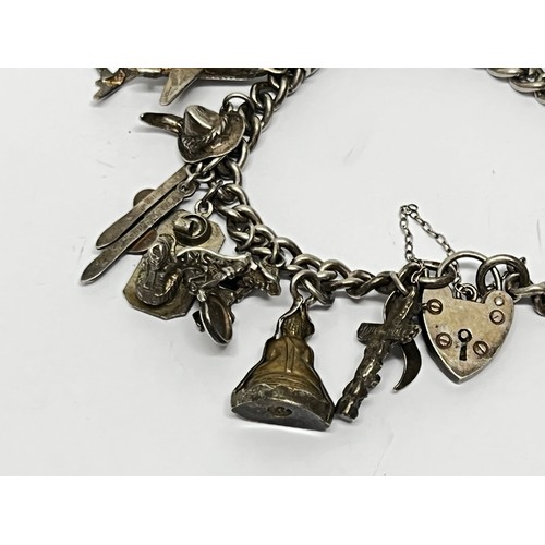 618 - Silver charm bracelet with approx 17 charms - gross 60.5g