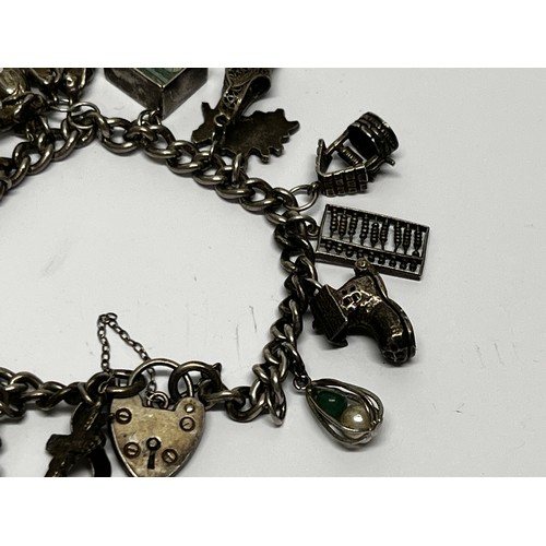 618 - Silver charm bracelet with approx 17 charms - gross 60.5g