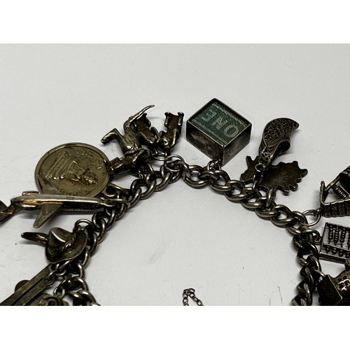 618 - Silver charm bracelet with approx 17 charms - gross 60.5g