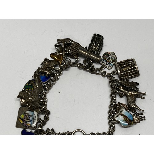 616 - Silver charm bracelet with approx 19 charms 65g