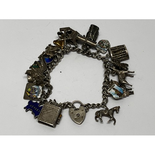 616 - Silver charm bracelet with approx 19 charms 65g